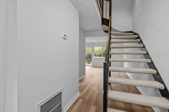 a view of entryway and hall with wooden floor