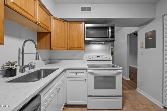 a kitchen with a stove microwave and sink