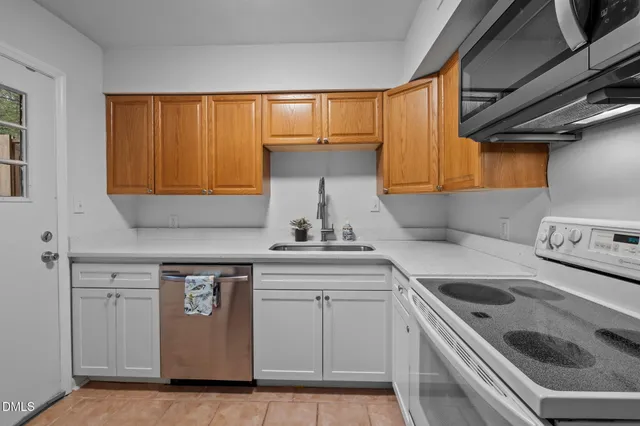 a kitchen with a sink stove and cabinets