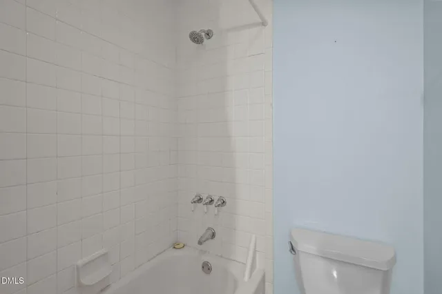 a bathroom with a bathtub and a toilet