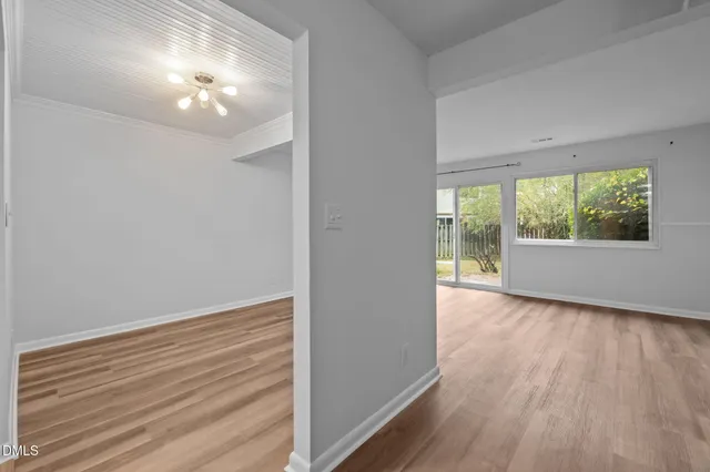 a view of a room with wooden floor and window