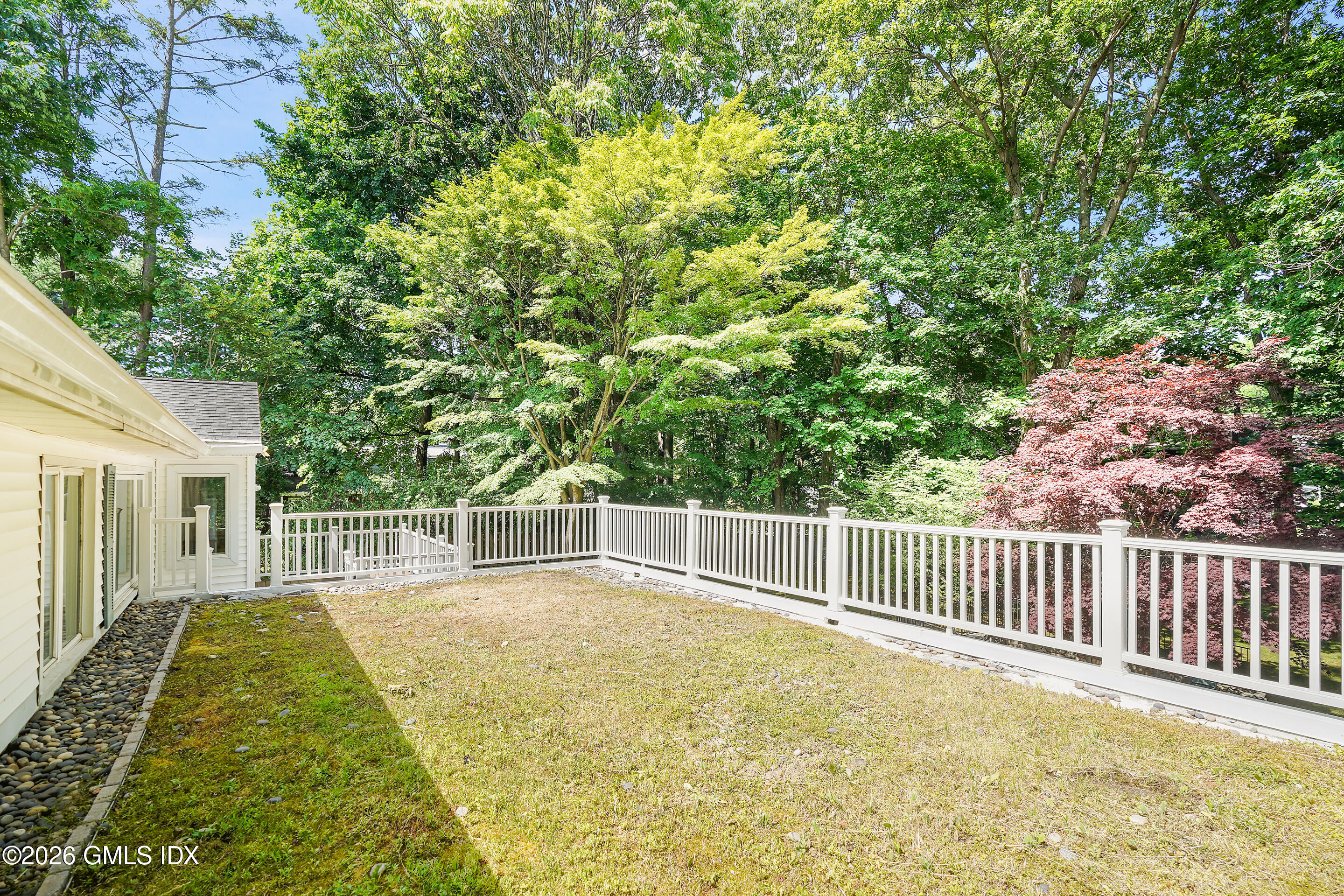 33 Sachem Road Greenwich, CT 06830 - Photo 26 of 35 a view of a backyard with a small yard