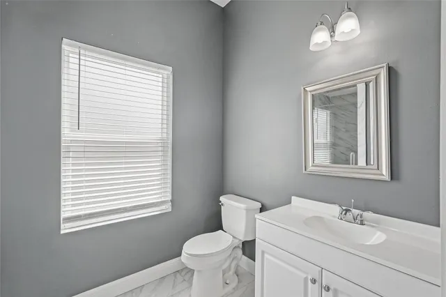 an empty room with a ceiling fan and carpet