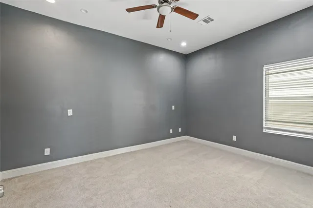 a spacious bathroom with a toilet a sink a light fixture and a window