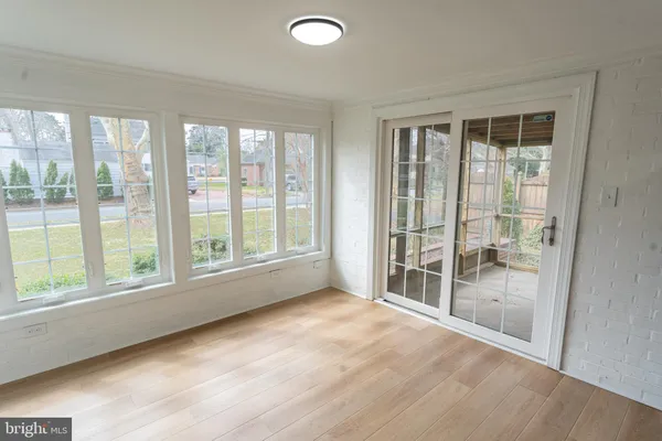 a view of a room with wooden floor and iron stairs