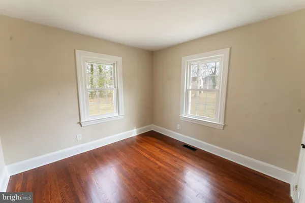 a view of an entryway with wooden floor and windows