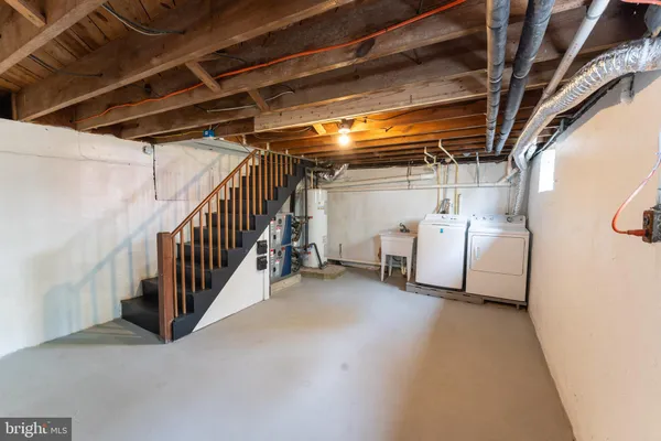 a front view of house with yard and trees in the background