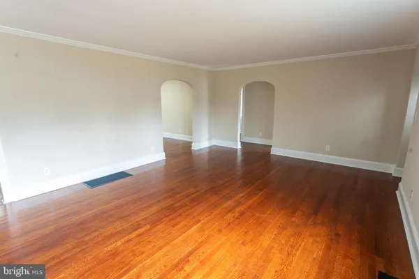a view of room with window and wooden floor