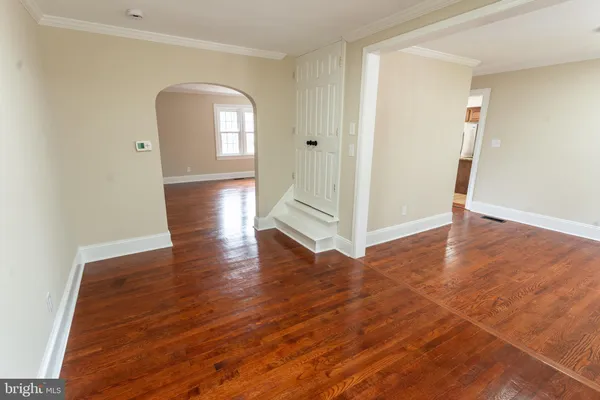 a view of a room with wooden floor and window
