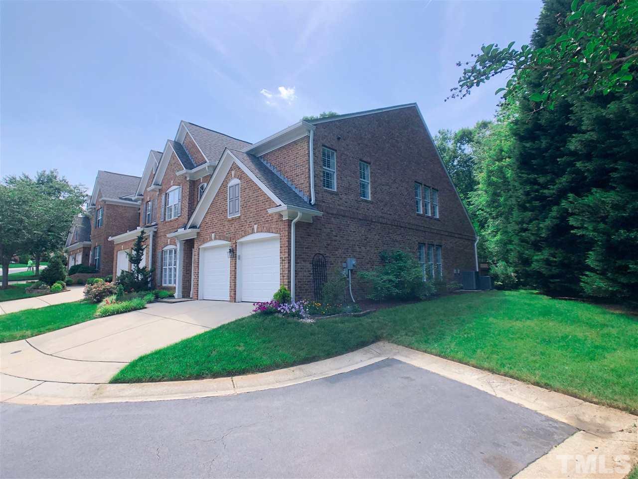 3927 Sunset Maple Court Raleigh, NC 27612 - Photo 2 of 18 a front view of a house with a yard and garage