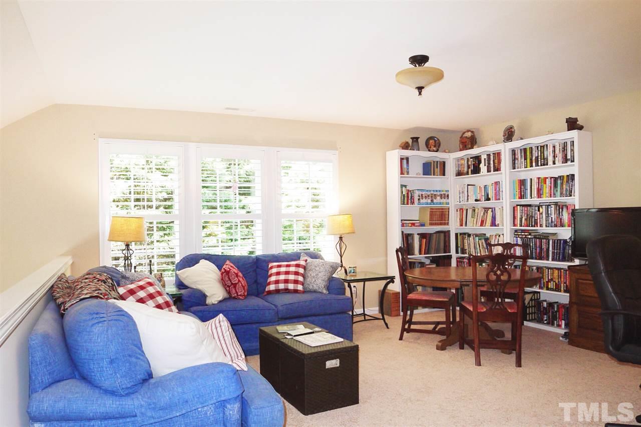 3927 Sunset Maple Court Raleigh, NC 27612 - Photo 13 of 18 a living room with furniture and a floor to ceiling window