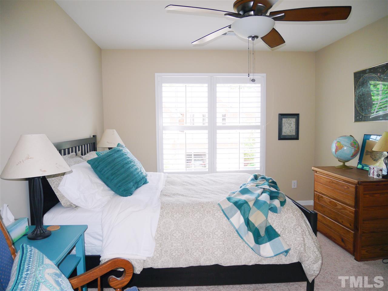 3927 Sunset Maple Court Raleigh, NC 27612 - Photo 15 of 18 a bedroom with a bed and window