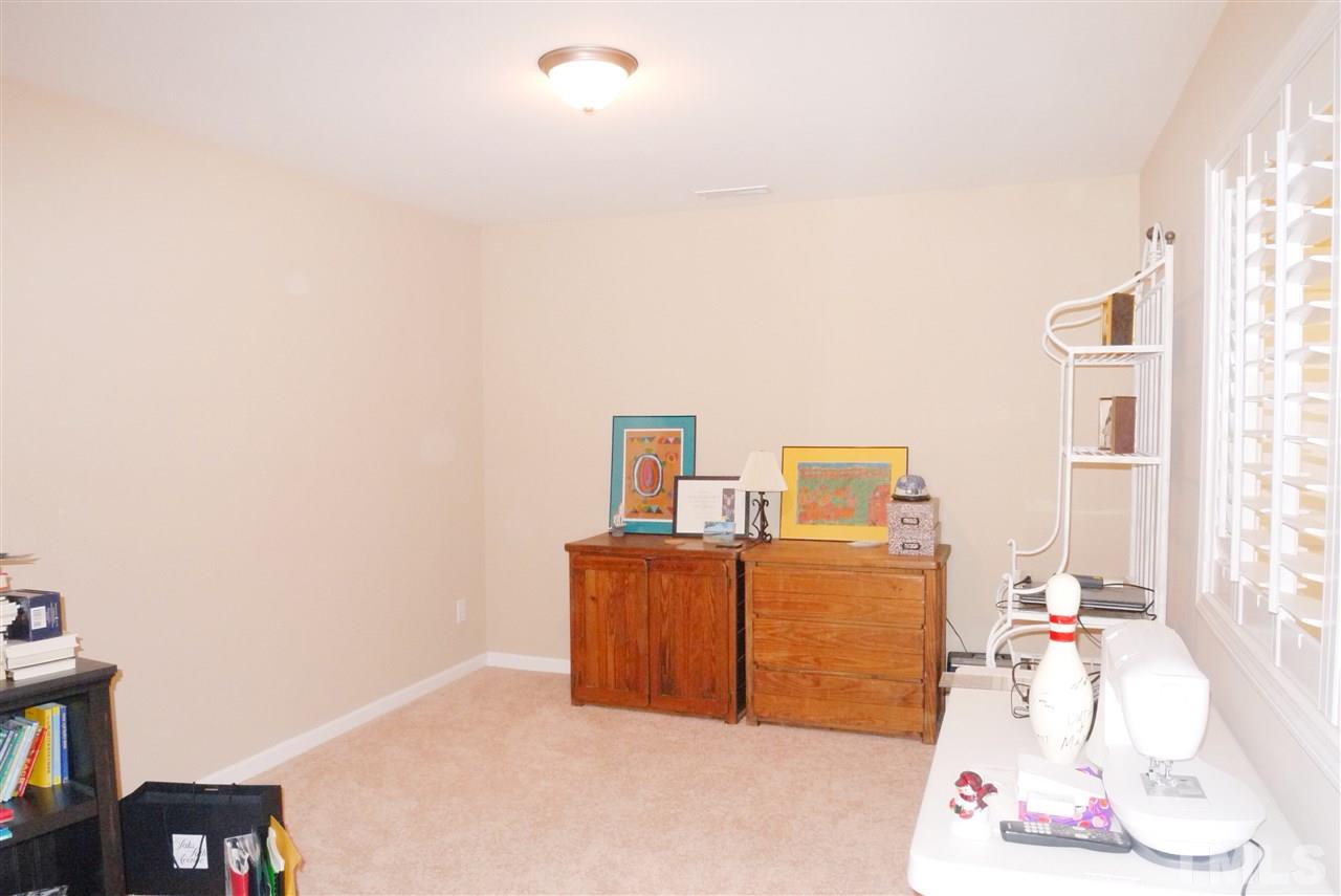 3927 Sunset Maple Court Raleigh, NC 27612 - Photo 16 of 18 a bedroom with a bed and wooden floor