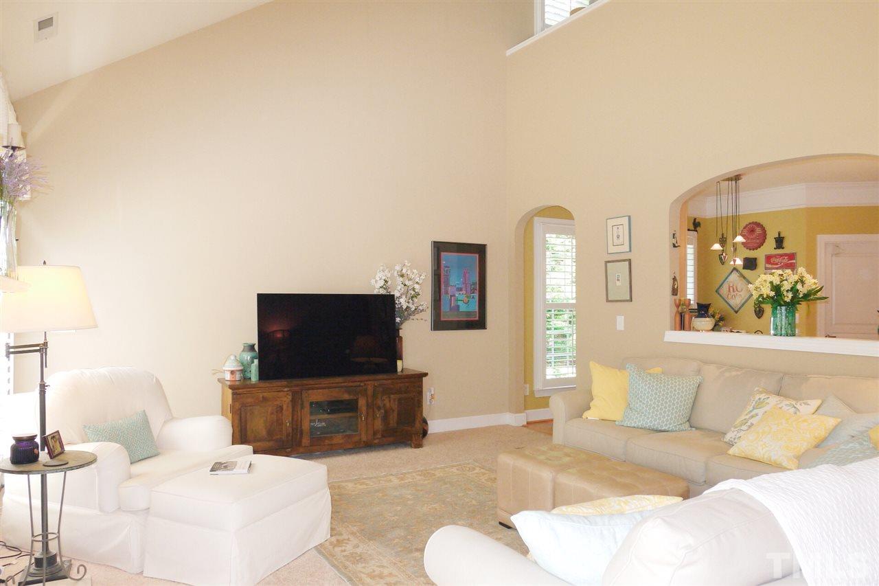 3927 Sunset Maple Court Raleigh, NC 27612 - Photo 10 of 18 a living room with furniture and a flat screen tv