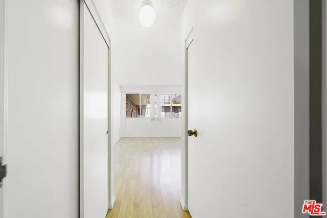 a view of a hallway with wooden floor