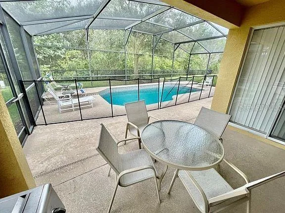 a view of a swimming pool with a patio