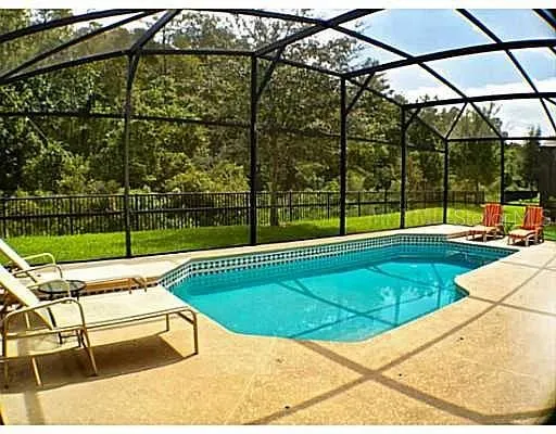 a kitchen with stainless steel appliances kitchen island granite countertop a stove a sink dishwasher and a microwave oven with large wooden cabinets