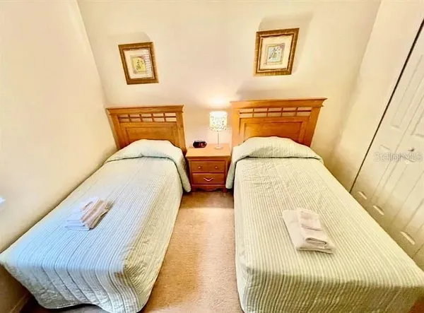 a bed sitting in a bedroom next to a window