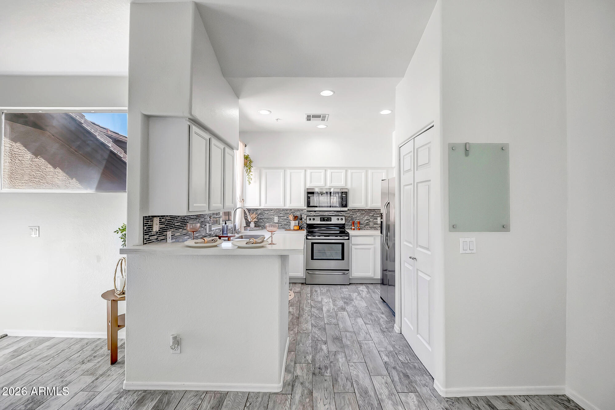 1445 East Broadway Road, Unit 208 Tempe, AZ 85282 - Photo 12 of 29 a kitchen with stainless steel appliances a refrigerator and a stove top oven