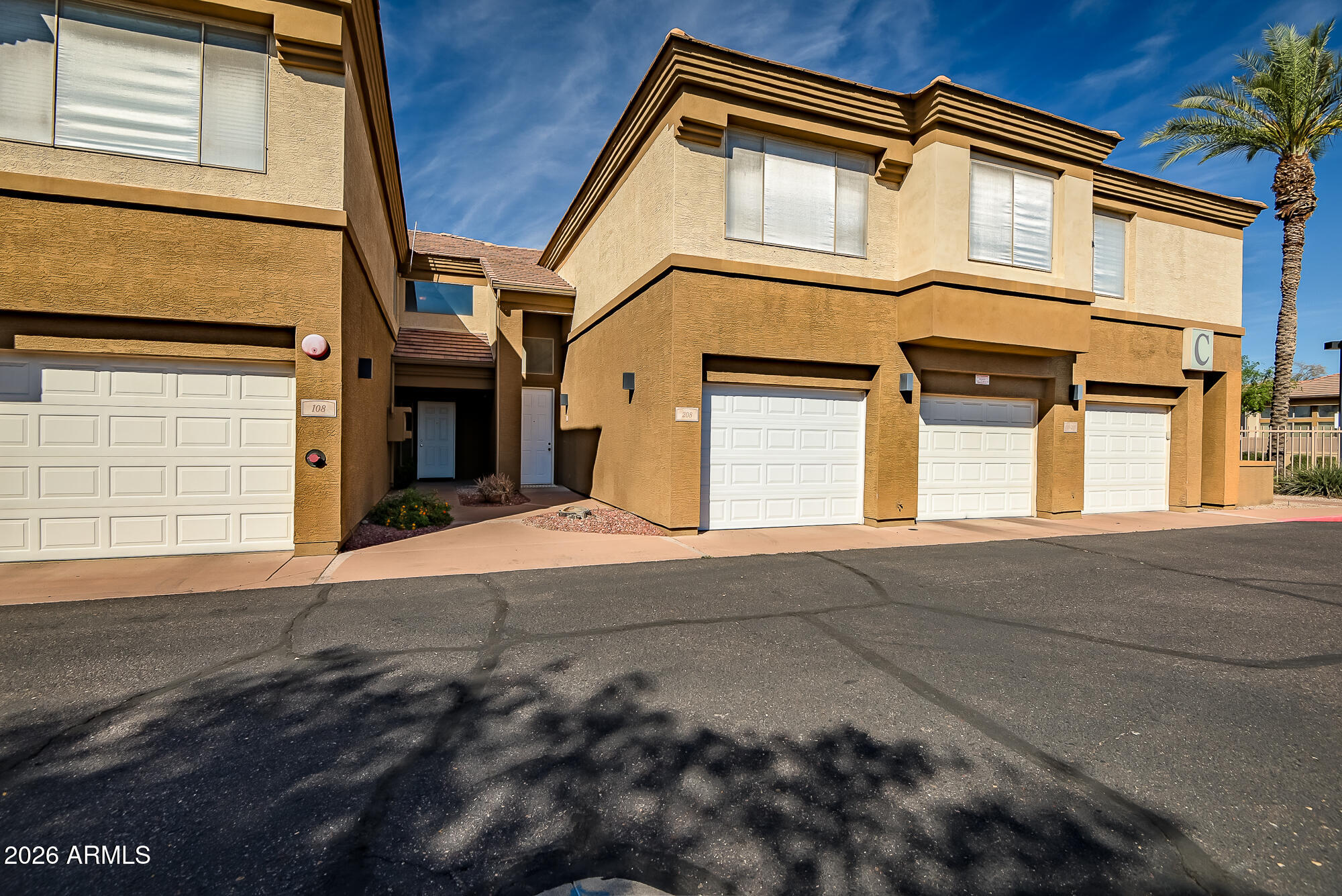 1445 East Broadway Road, Unit 208 Tempe, AZ 85282 - Photo 2 of 29 a front view of a house with a garage