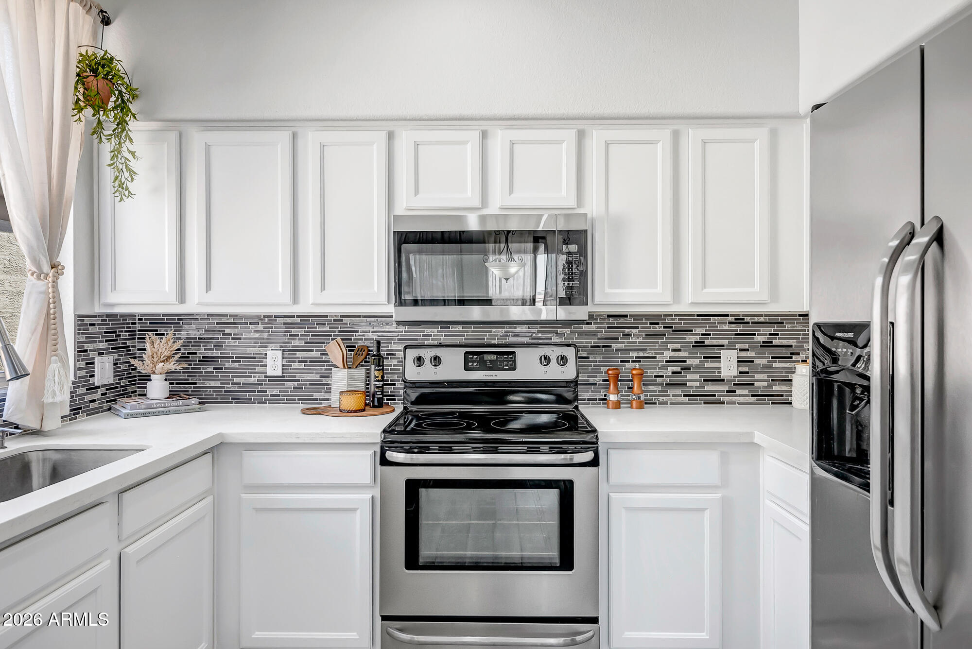 1445 East Broadway Road, Unit 208 Tempe, AZ 85282 - Photo 5 of 29 a kitchen with white cabinets and stainless steel appliances