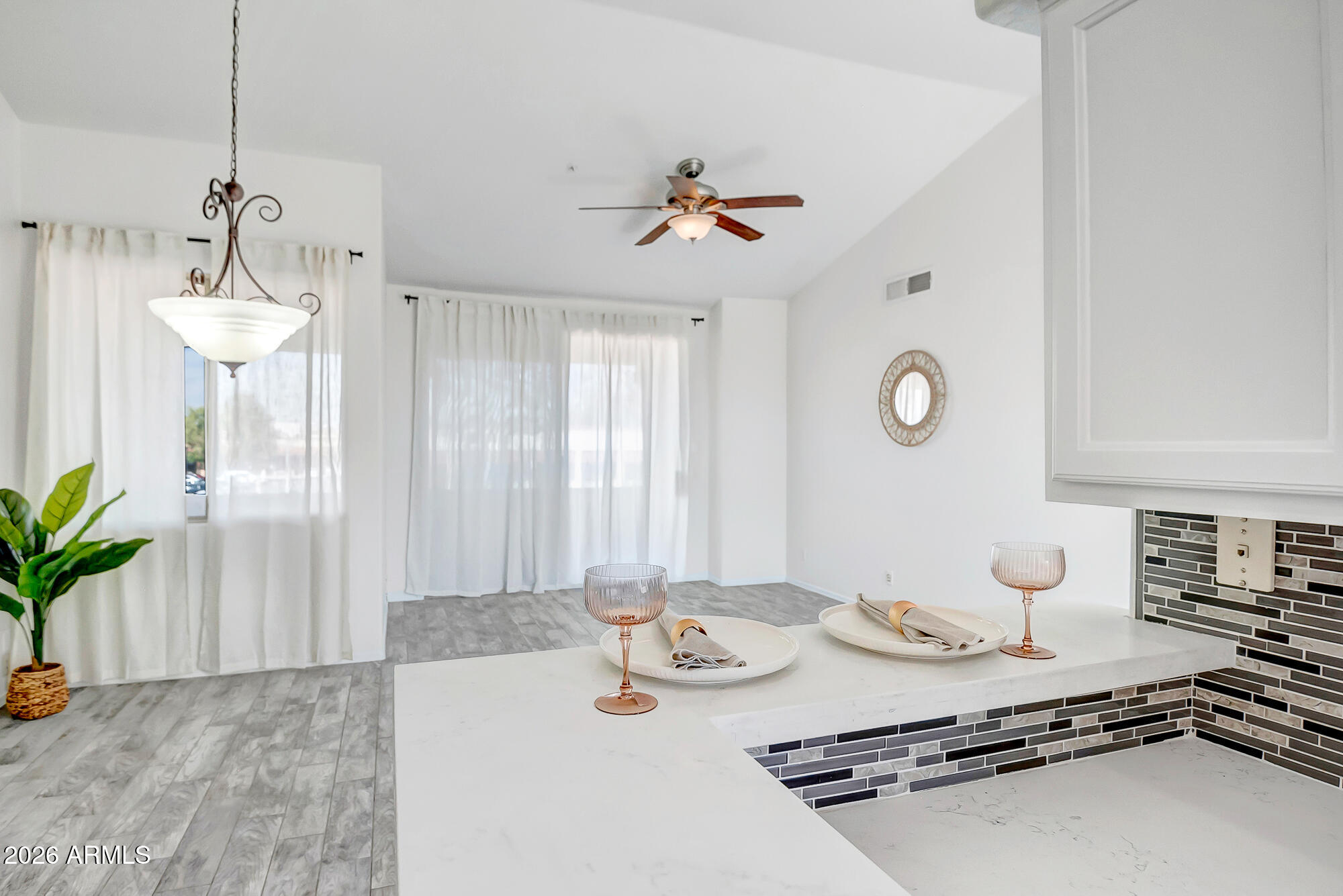 1445 East Broadway Road, Unit 208 Tempe, AZ 85282 - Photo 7 of 29 a view of a dining room and kitchen island a chandelier