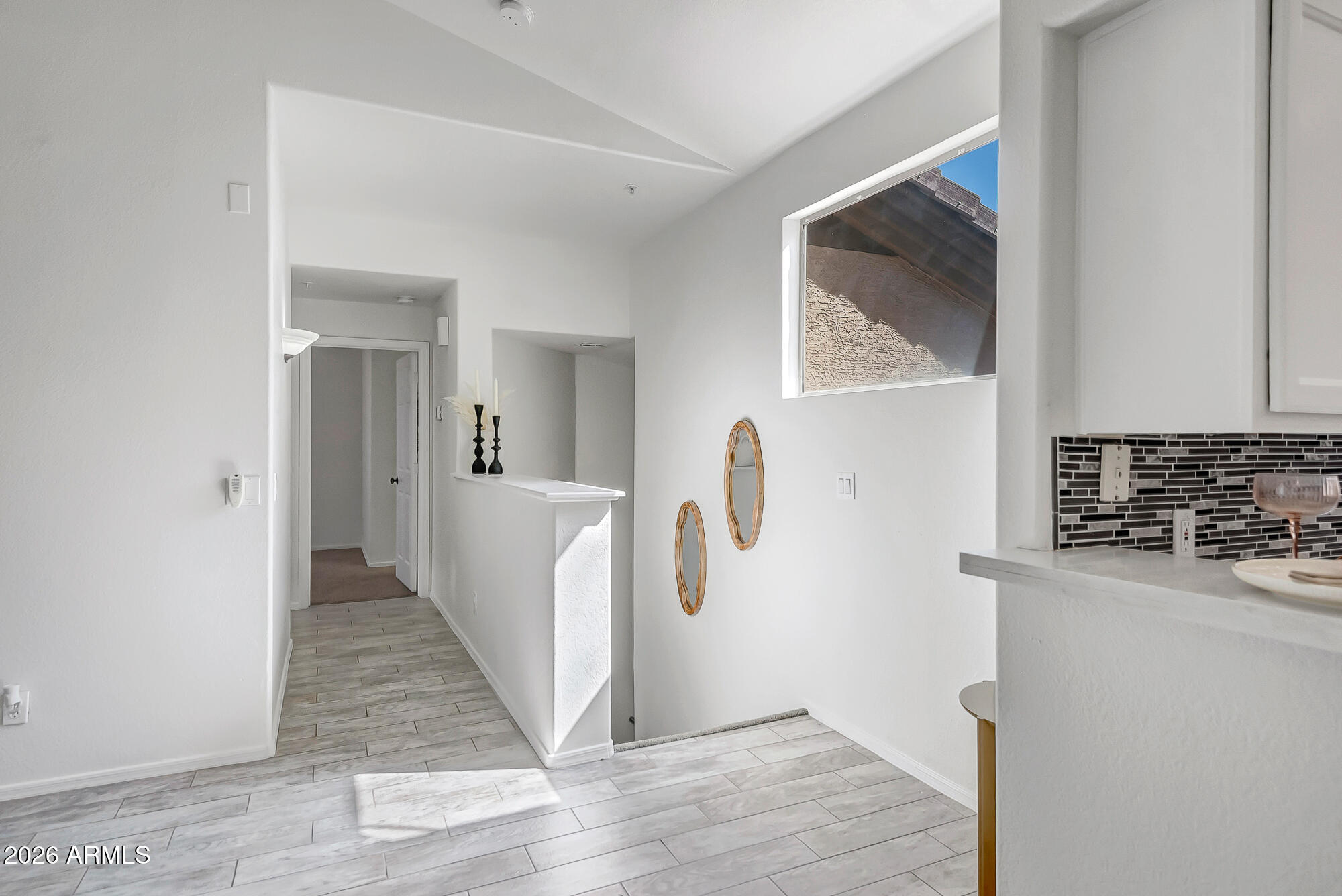 1445 East Broadway Road, Unit 208 Tempe, AZ 85282 - Photo 10 of 29 a view of a hallway with wooden floor and cabinets