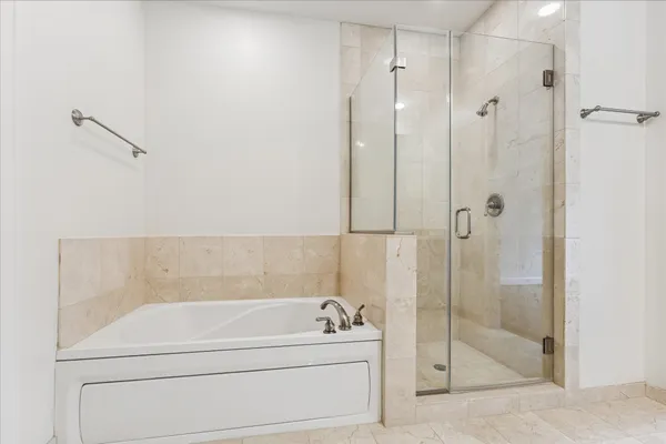 a bathroom with a bathtub and shower