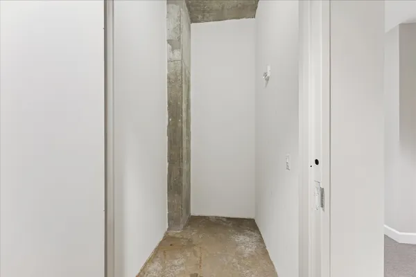 a view of staircase with white walls and a painting on the wall