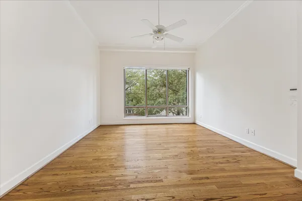 wooden floor in an empty room with a window