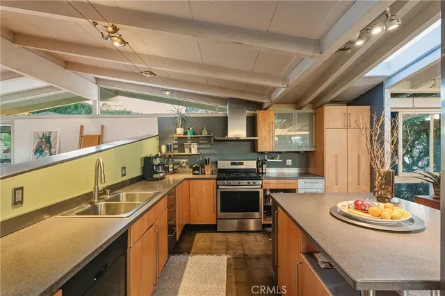 a kitchen with stainless steel appliances granite countertop a sink dishwasher and cabinets with wooden floor