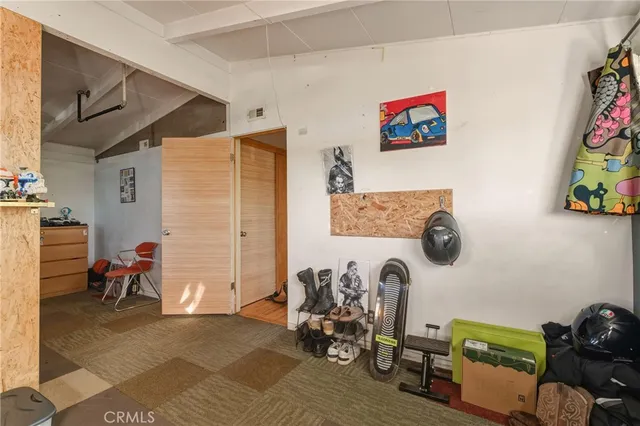 a bedroom with furniture and a flat screen tv