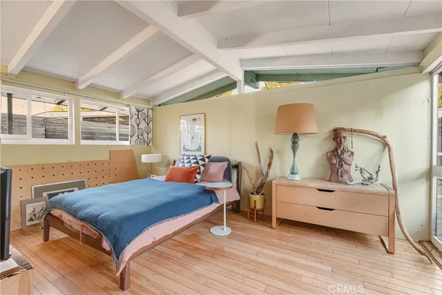 a bedroom with furniture and wooden floor