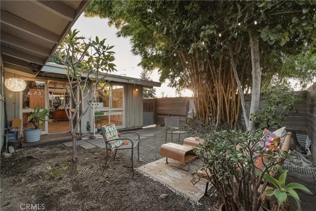 a view of a patio with table and chairs with wooden floor