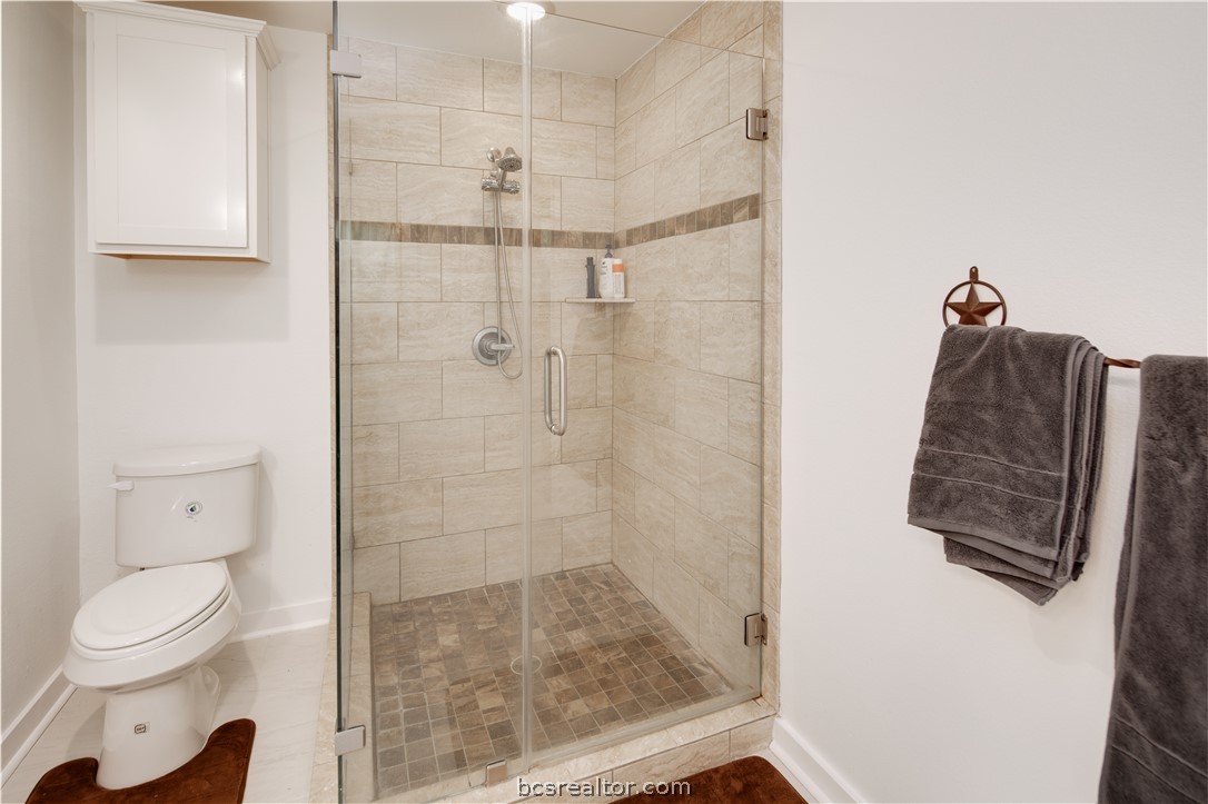 1204 East 28th Street Bryan, TX 77803 - Photo 13 of 22 a bathroom with a shower and toilet