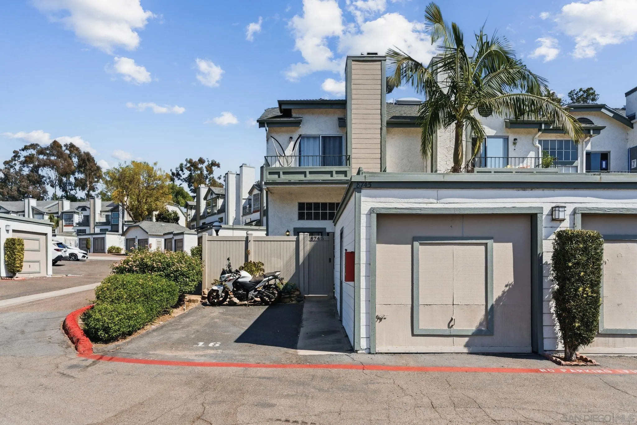 8745 Spring Canyon Drive, Unit 16 Spring Valley, CA 91977 - Photo 1 of 40 a front view of a house with a yard and garage
