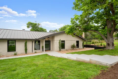 a front view of house with yard and green space