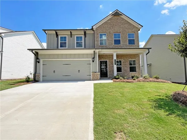 a front view of a house with a yard