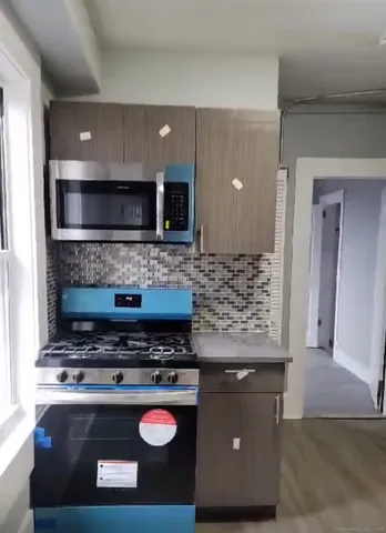 a living room with a stove and a microwave