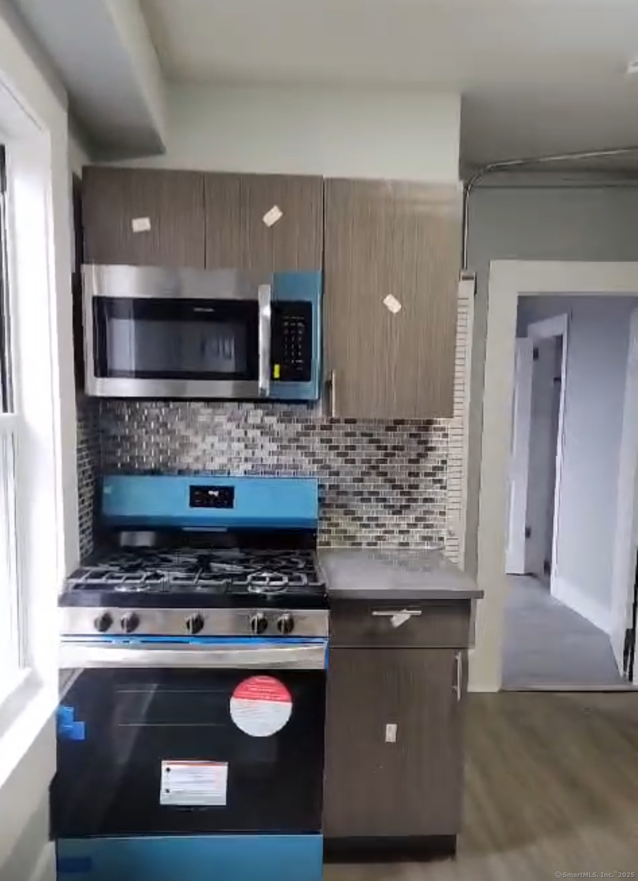 a living room with a stove and a microwave