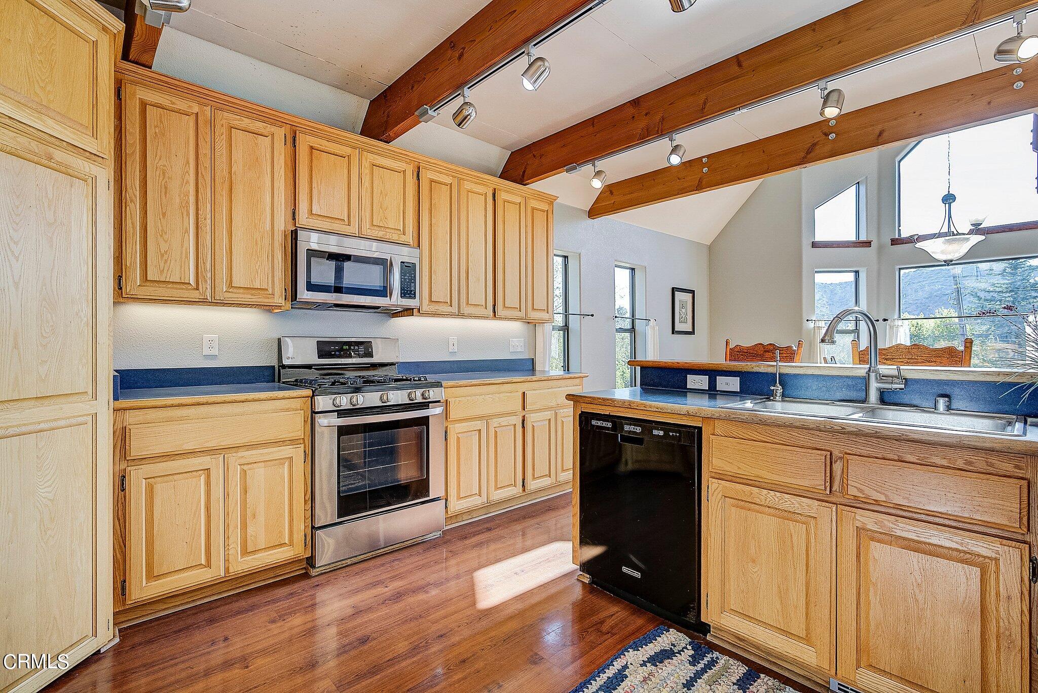 5390 Locarno Drive Wrightwood, CA 92397 - Photo 12 of 33 a kitchen with stainless steel appliances granite countertop a stove a sink and a microwave