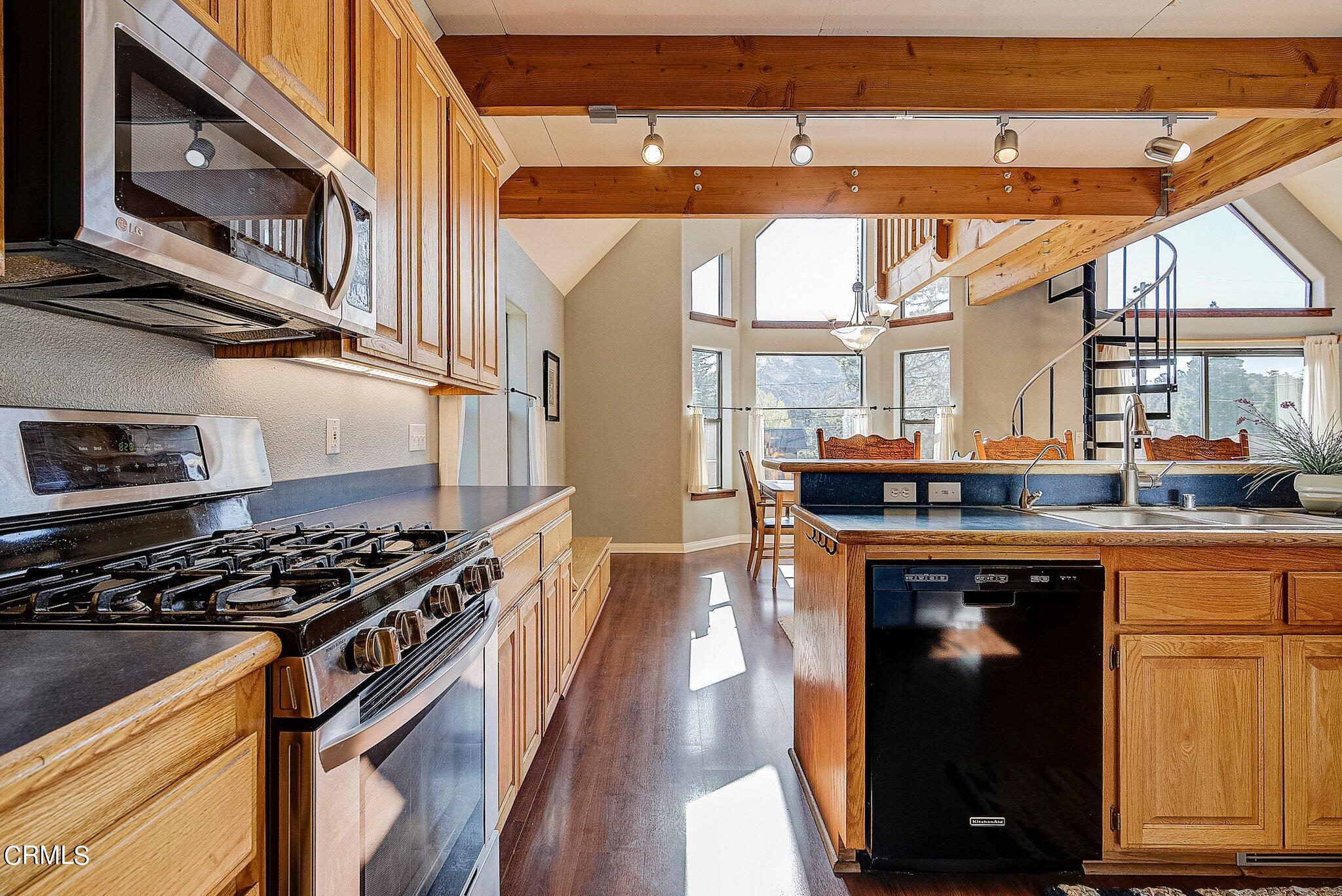 5390 Locarno Drive Wrightwood, CA 92397 - Photo 13 of 33 a kitchen with stainless steel appliances granite countertop a stove and a refrigerator
