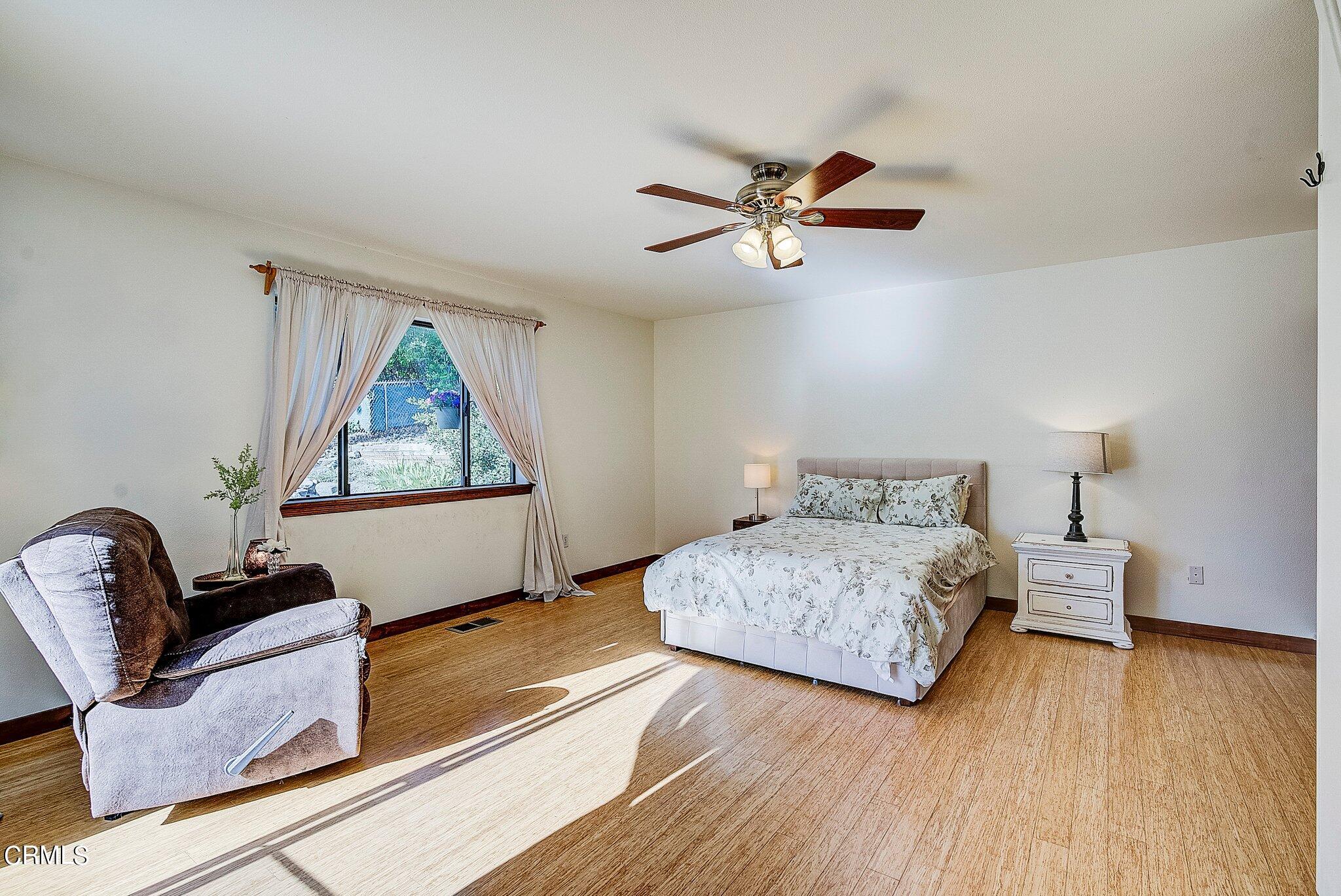 5390 Locarno Drive Wrightwood, CA 92397 - Photo 22 of 33 a bedroom with a bed and wooden floor