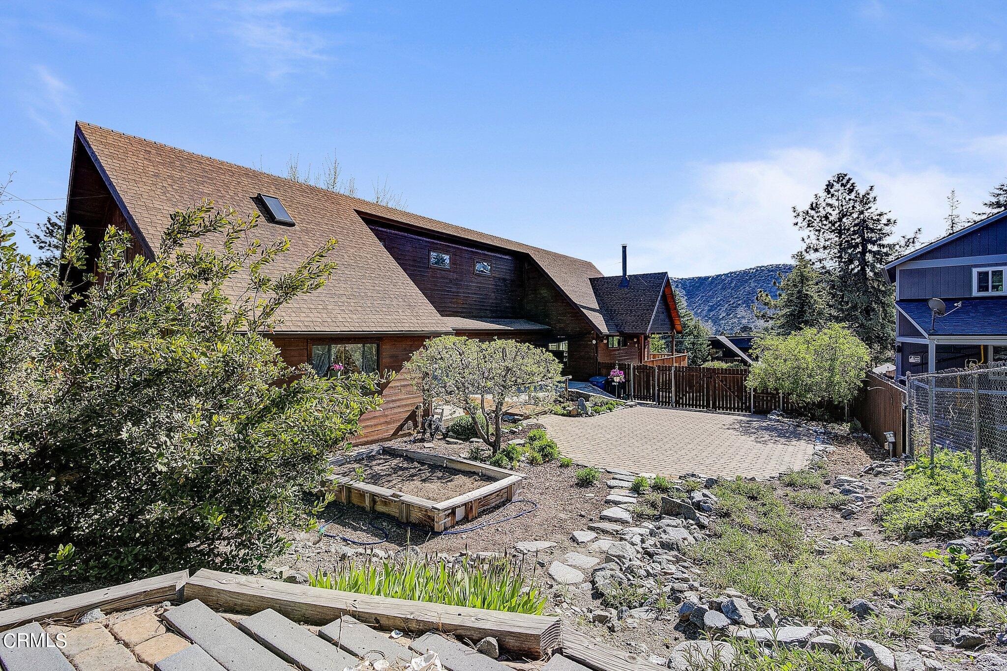 5390 Locarno Drive Wrightwood, CA 92397 - Photo 29 of 33 a wooden bench sitting in the middle of a backyard