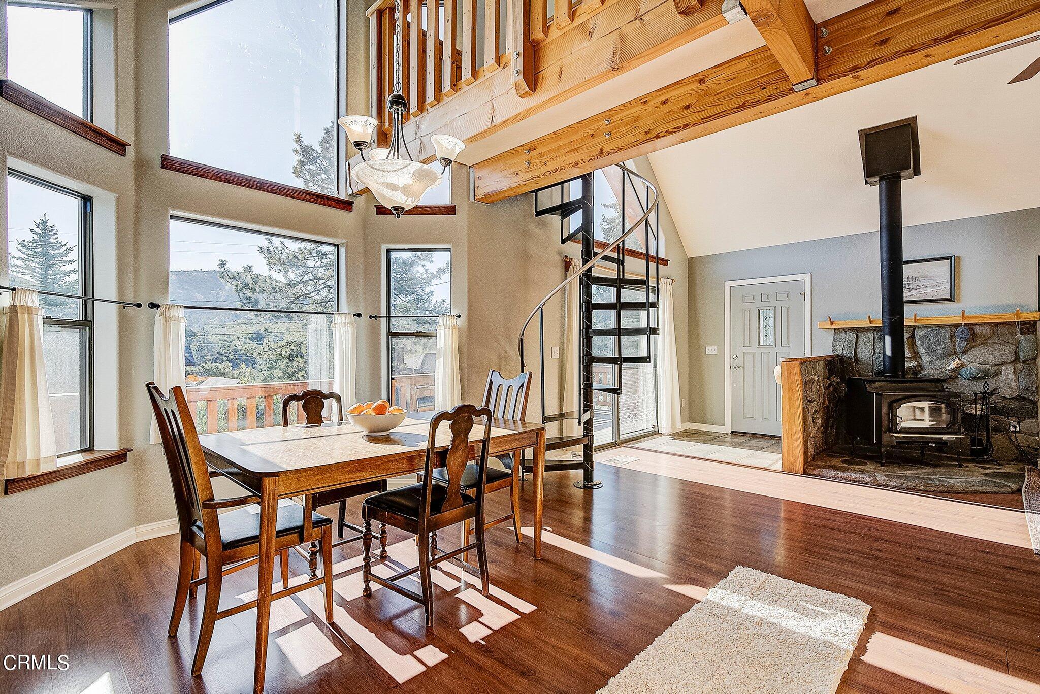 5390 Locarno Drive Wrightwood, CA 92397 - Photo 7 of 33 a dining room with furniture a fireplace and wooden floor