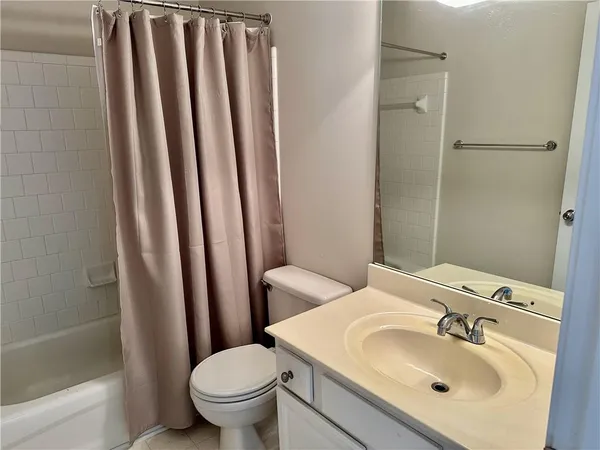 a bathroom with a sink toilet and mirror