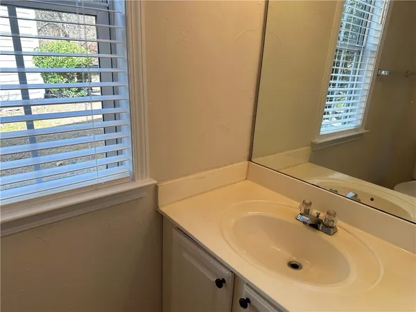 a bathroom with a sink and a window