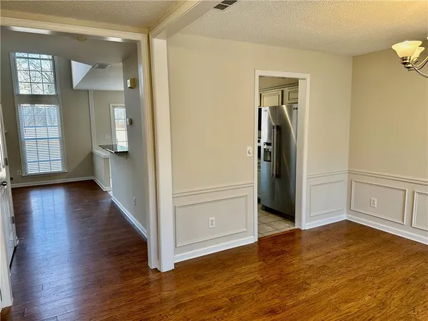an empty room with wooden floor and closet