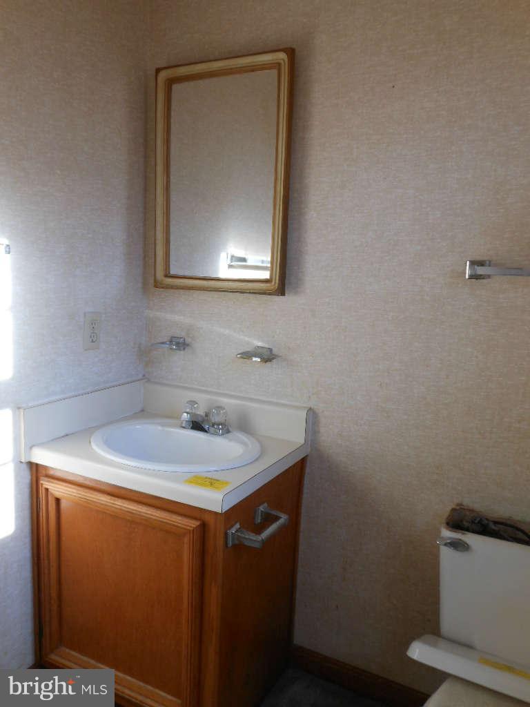 15140 Sheads Mountain Road Rixeyville, VA 22737 - Photo 12 of 12 a bathroom with a sink and a mirror