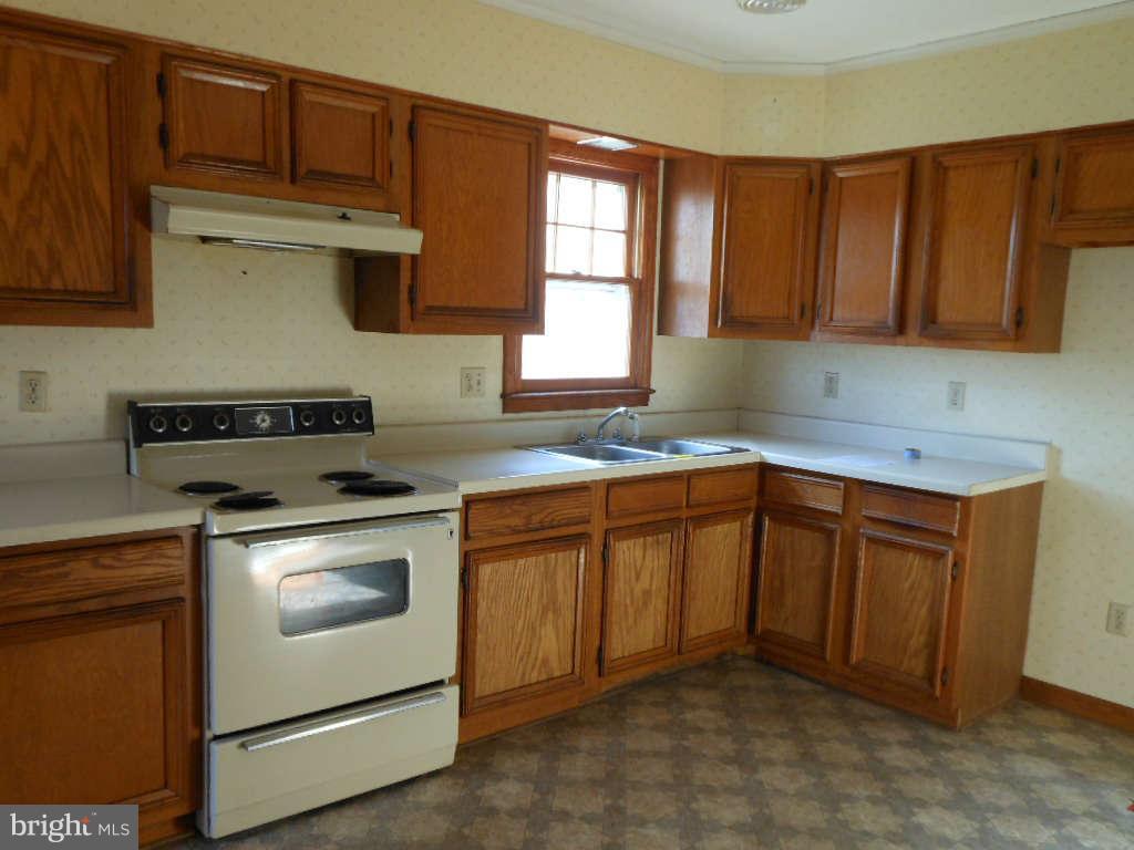 15140 Sheads Mountain Road Rixeyville, VA 22737 - Photo 6 of 12 a kitchen with granite countertop cabinets stainless steel appliances a sink and a window